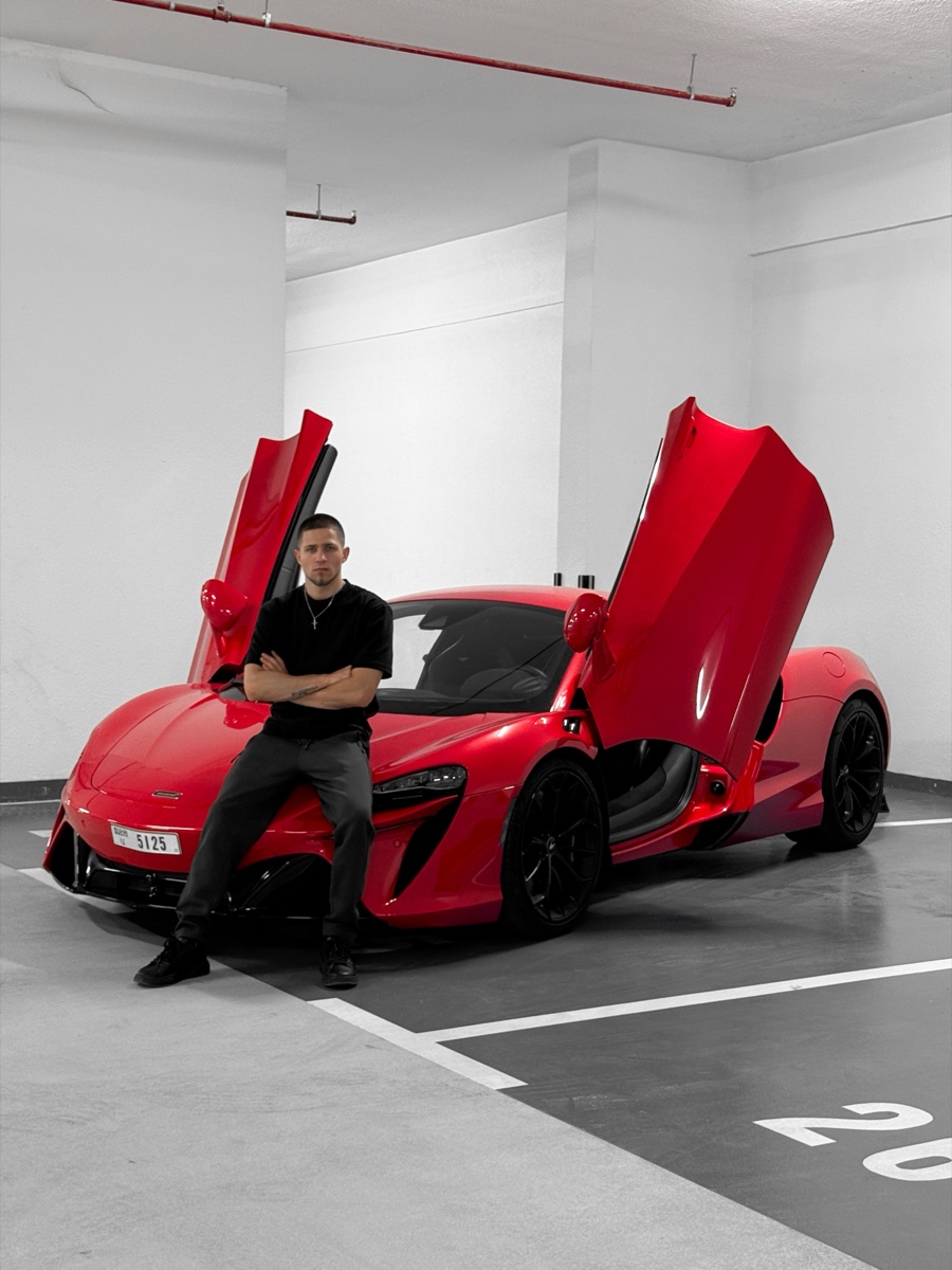 Roman Onta with a red McLaren in Dubai